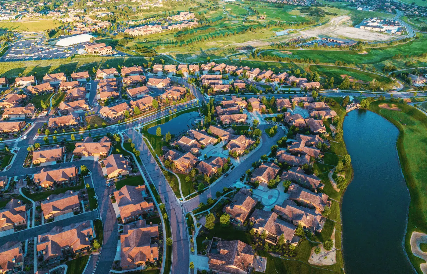 Elevated view of the Flying Horse community in north Colorado Springs with luxury homes, a golf course, and a lake