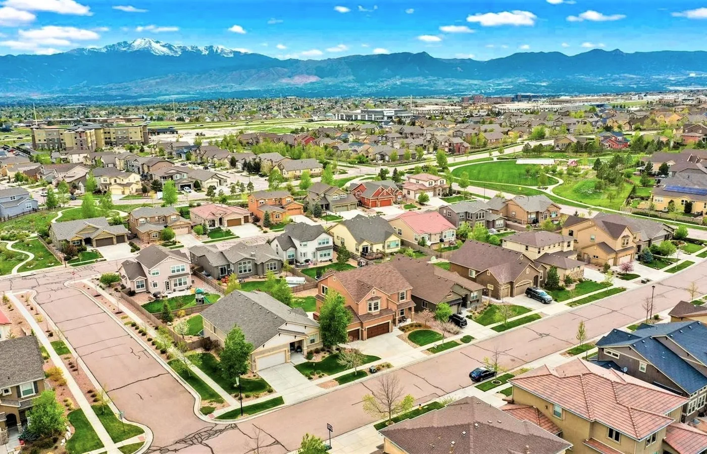 Elevated view of the Cordera neighborhood in Colorado Springs with mountain homes and the Front Range on the horizon