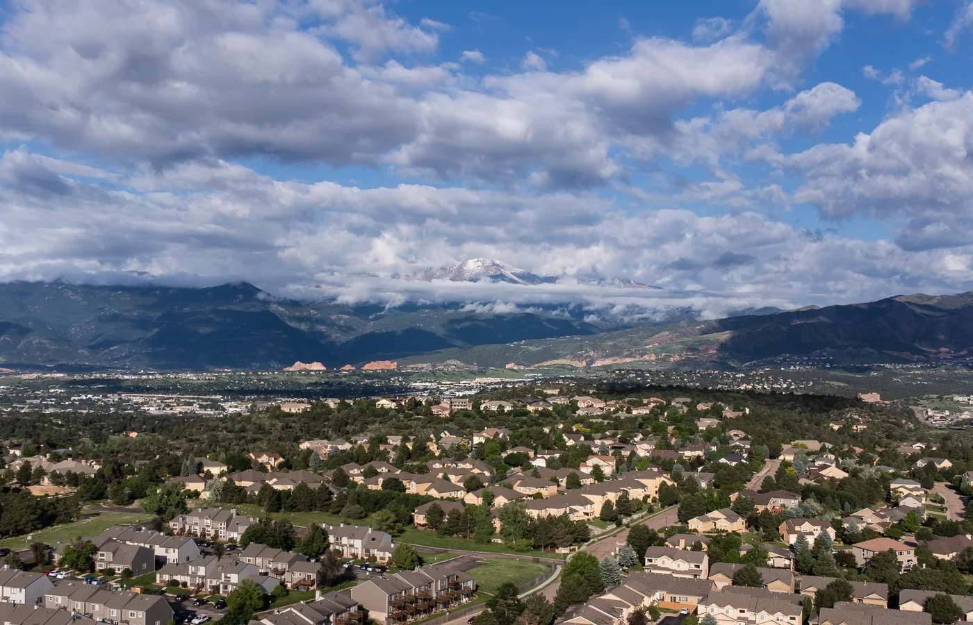 Elevated view of a Colorado Springs neighborhood with Pikes Peak and Garden of the Gods in the distance