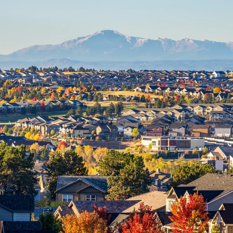 North Colorado Springs master-planned neighborhood with Pikes Peak in the background on an autumn day